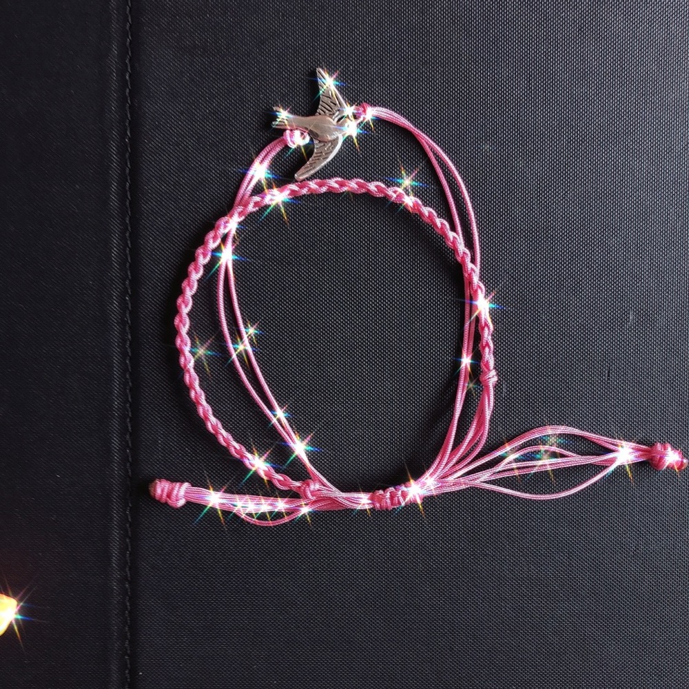 Set of handmaid charm and braid bracelet.